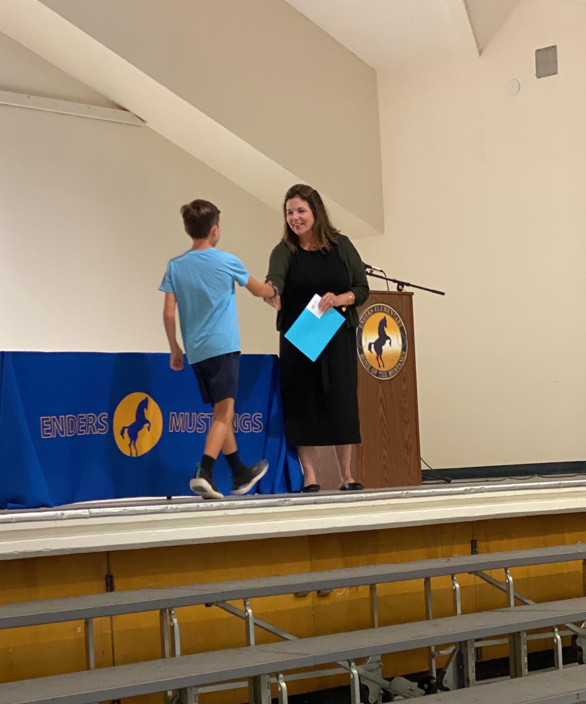Student receiving award from Mrs. Rushall